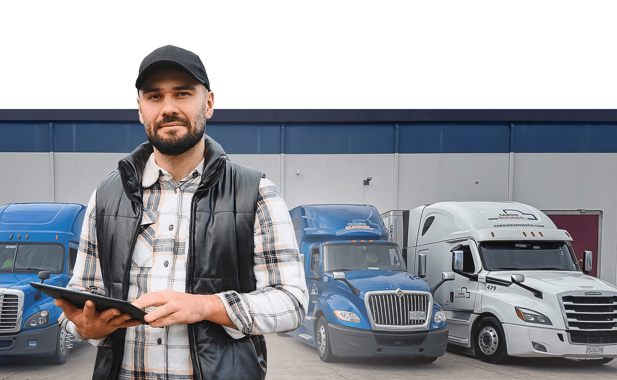 Cargo Runner driver standing in front of the company fleet